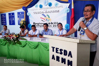 Minister Mohaqher Iqbal of Ministry of Basic, Higher and Technical Education (MBHTE-BARMM) announces the appointment of Director Ruby Andong during the regional skills competition in Maguindanao Friday, Aug. 9, 2019. (TESDA photo)
